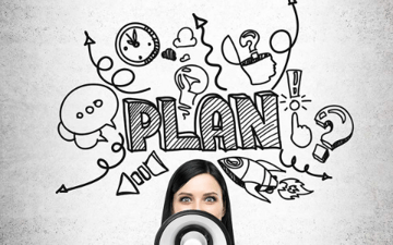 Woman with bullhorn and plan written in sharpie