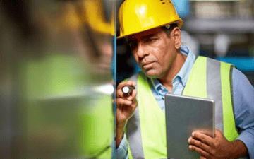 Maintenance planner looks over equipment during rounds