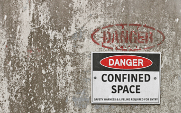 Danger sign on a concrete wall 