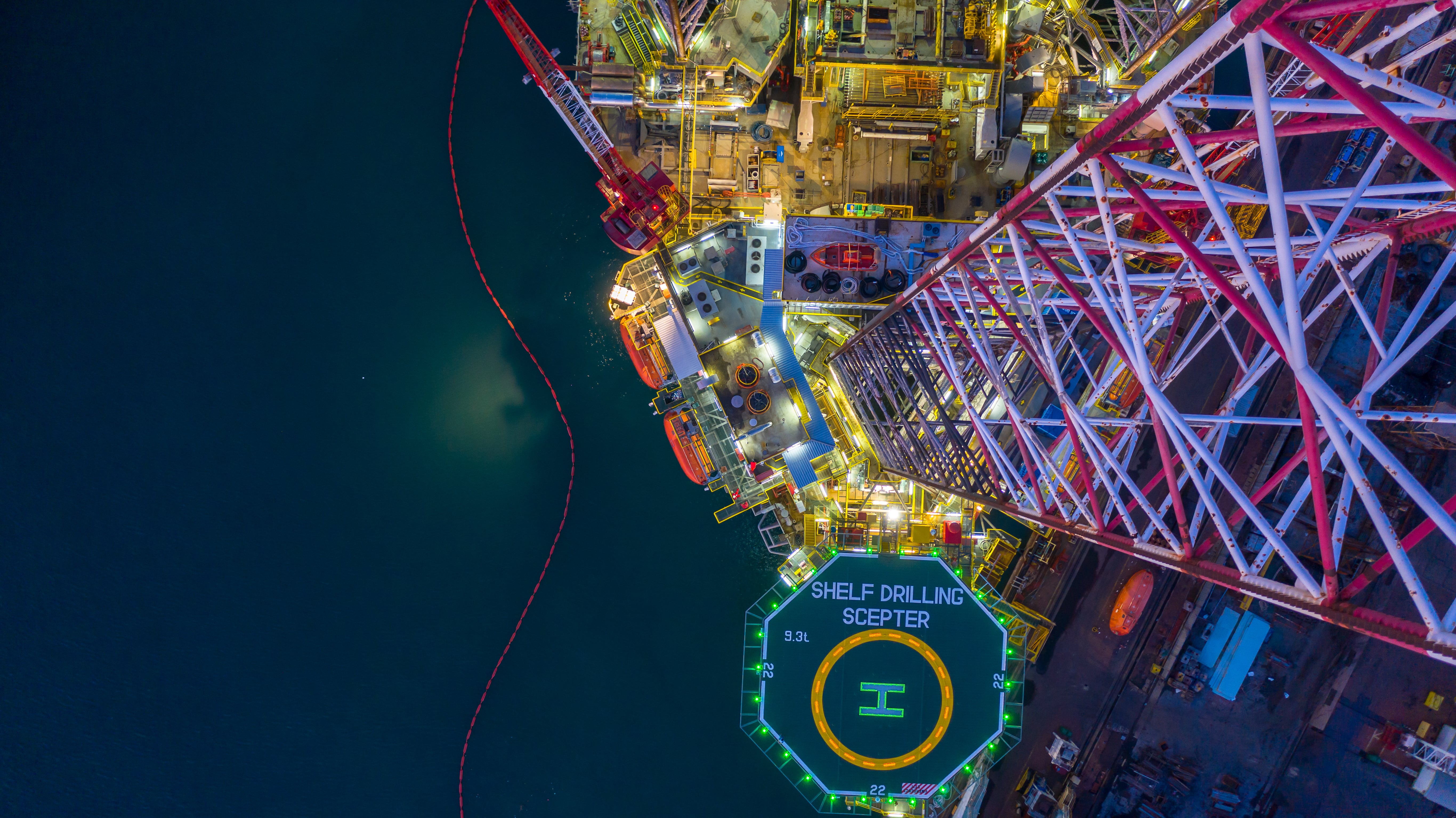 aireal view of a helicopter pad at the end of a offshore platform