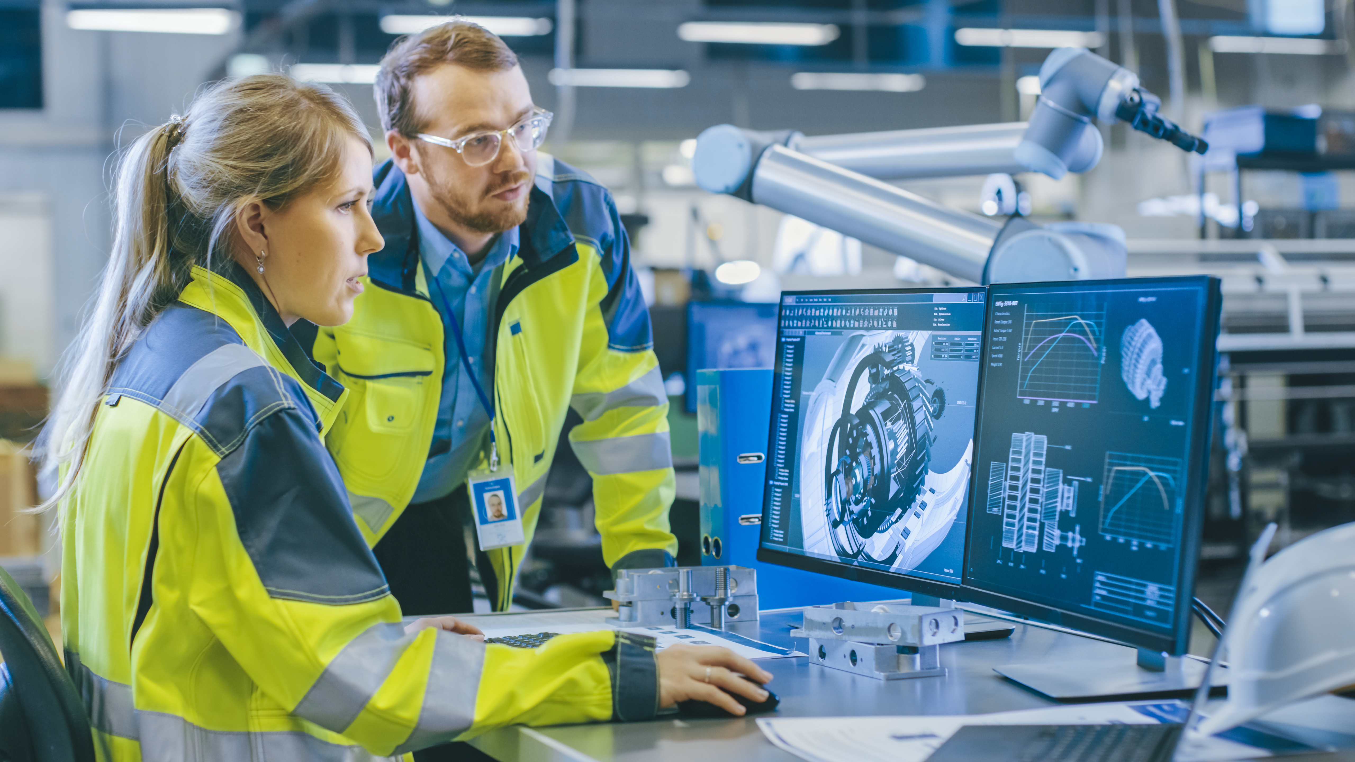 Male and female maintenance worker review blueprint