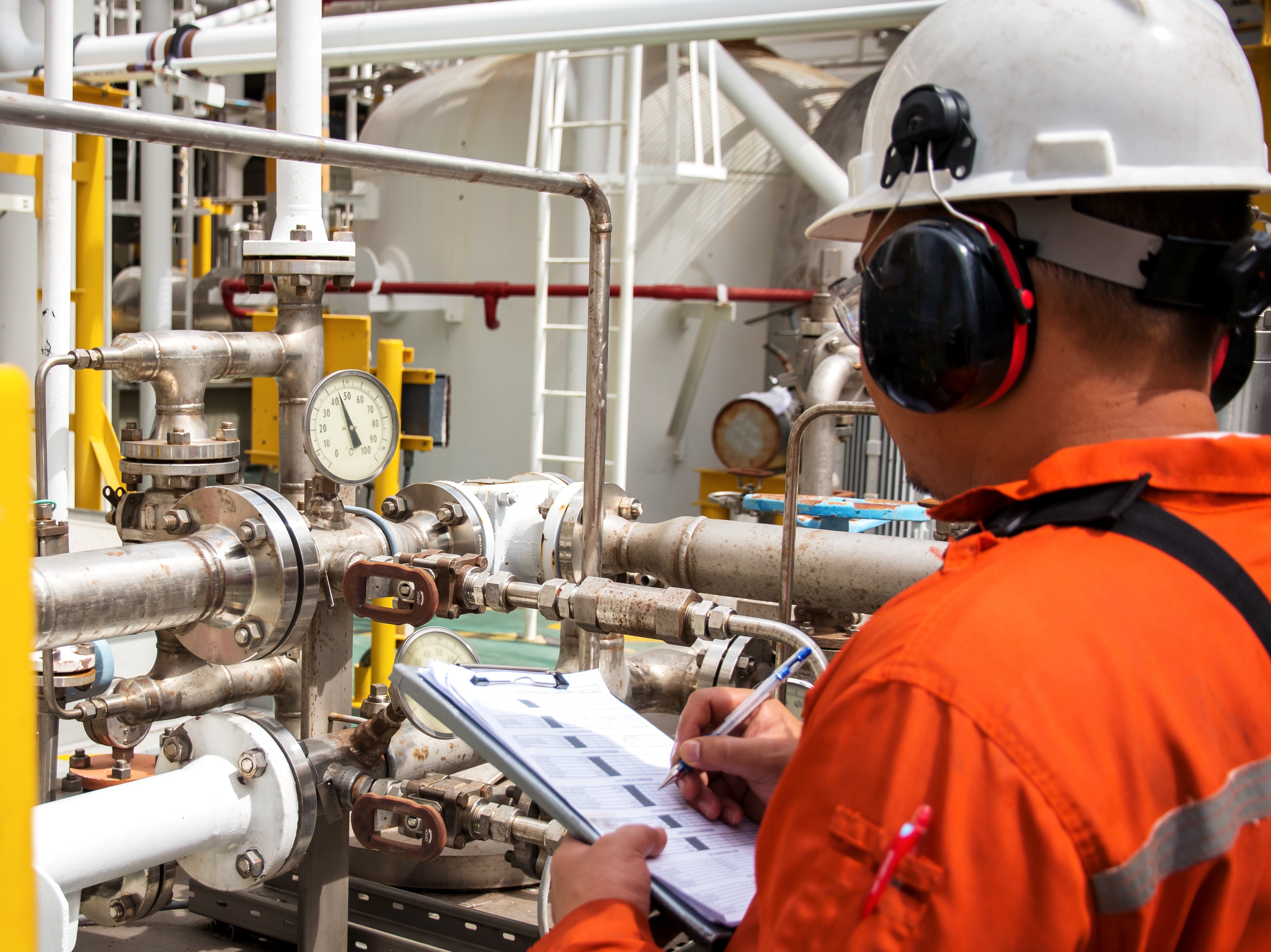 Maintenance technician checking pressure readings on a machine