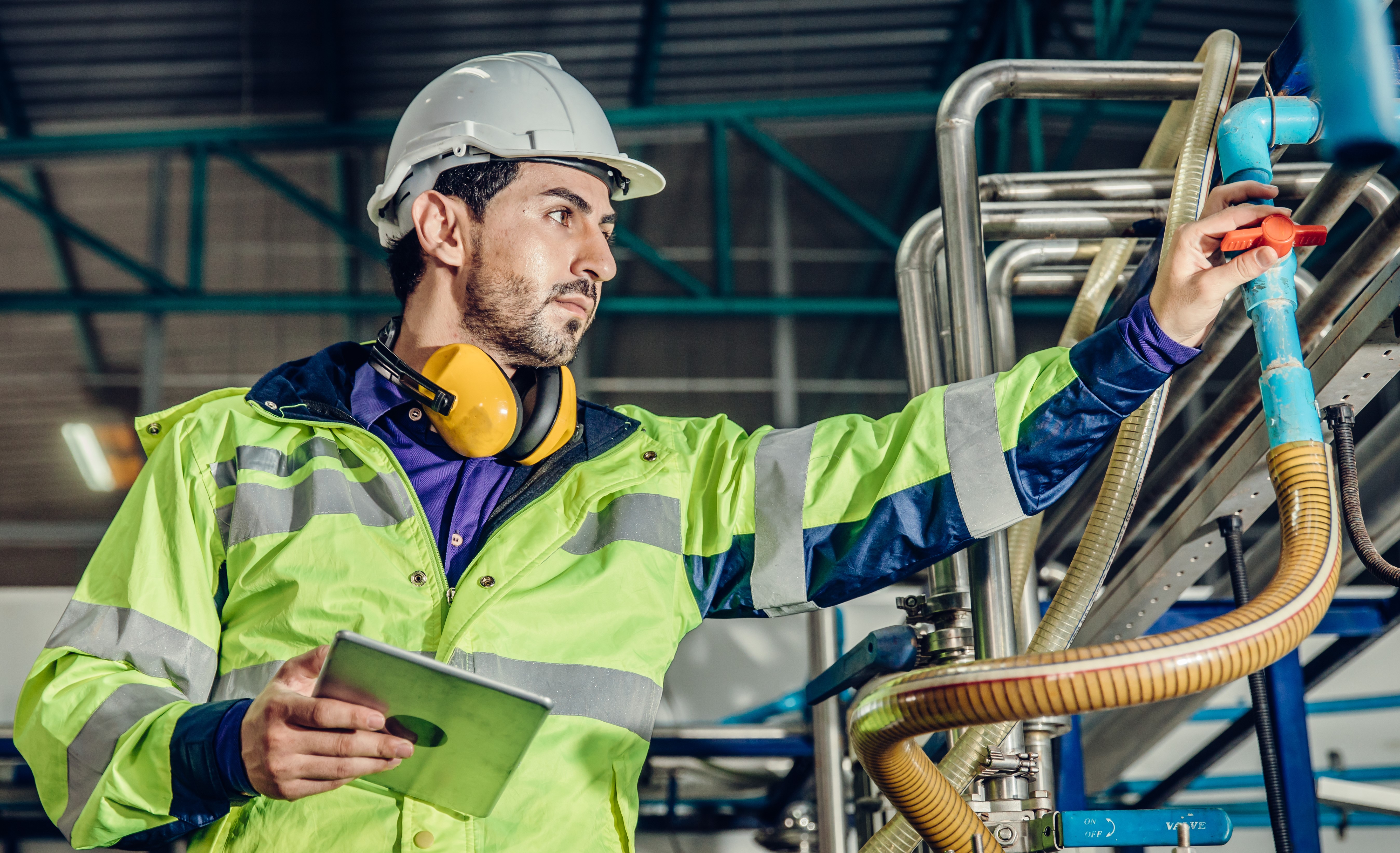 Maintenance technician adjusting valve