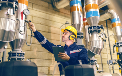 Maintenance technician checking the pressure of a machine