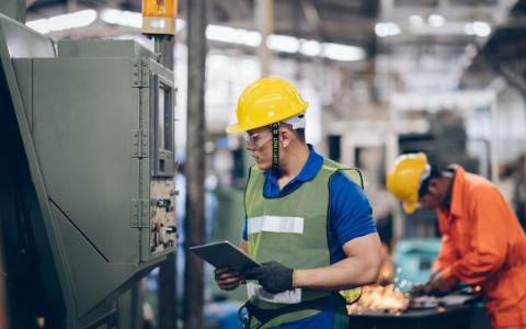 Maintenance technician checking reading on a machine